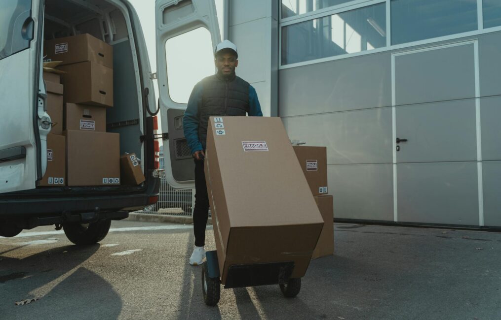 moving process Montreal team safely transporting large box on dolly