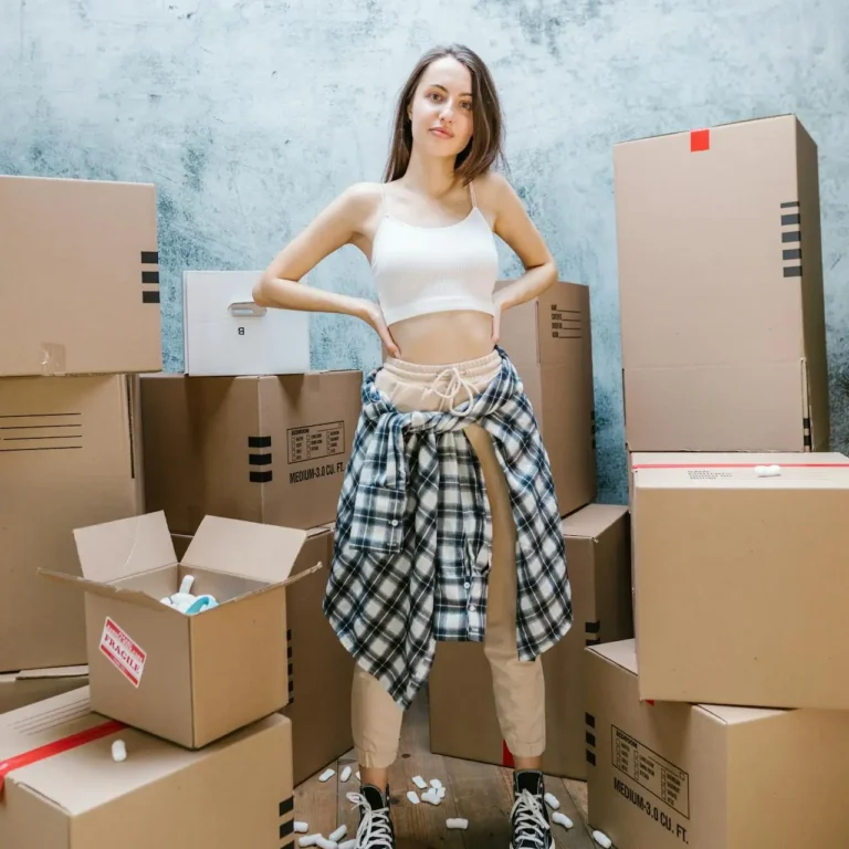 moving reviews Montreal happy customer standing with moving boxes after move