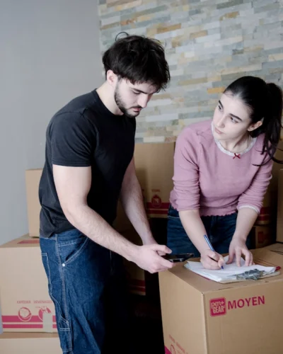 moving services Montreal couple packing boxes preparing for move